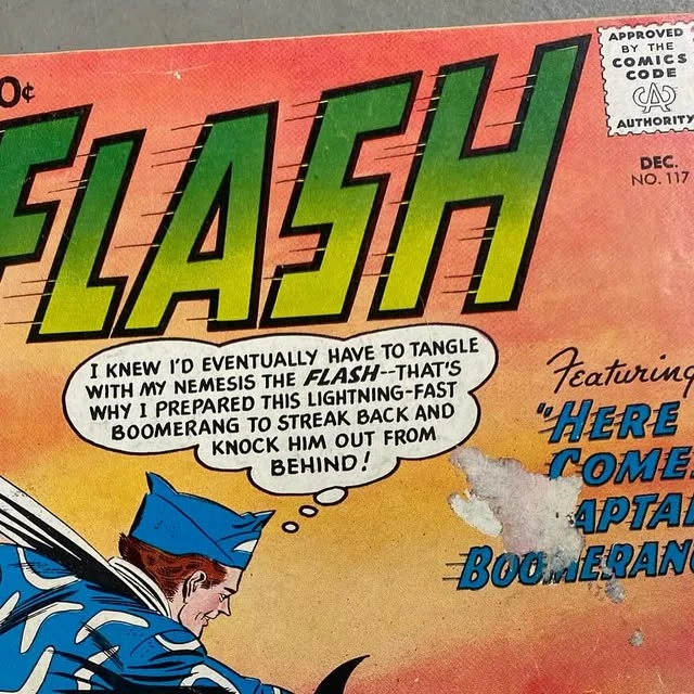 Close view of a vintage comic cover with bold Flash lettering and aged paper texture
