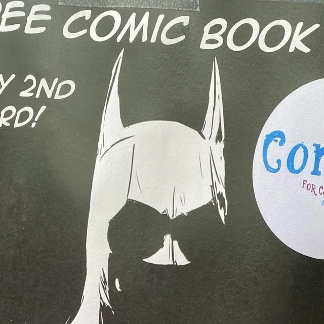 Black and white free comic detail with mask drawing and partial shop mark
